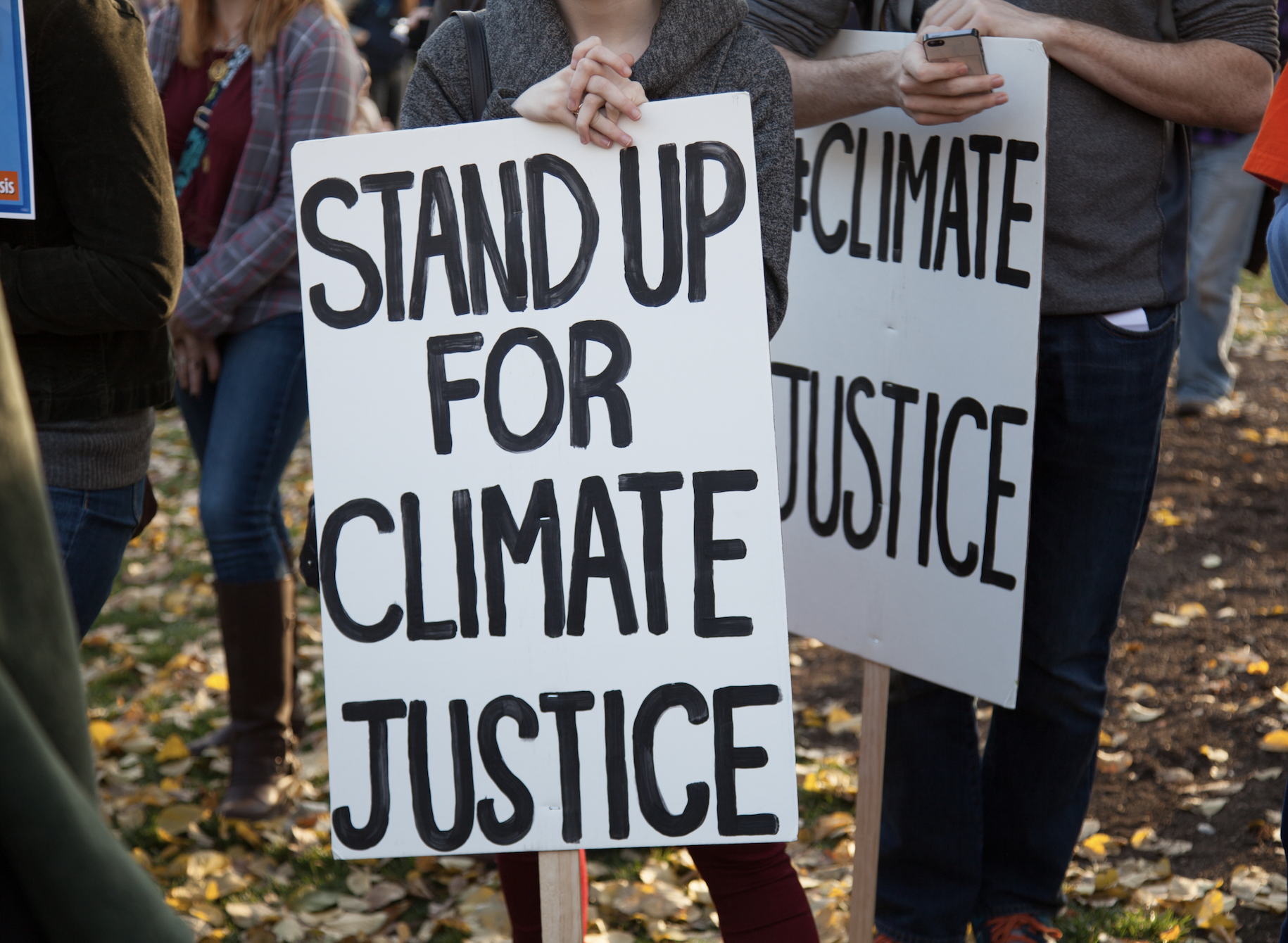 Image of a sign saying "Stand Up for Climate Justice" 