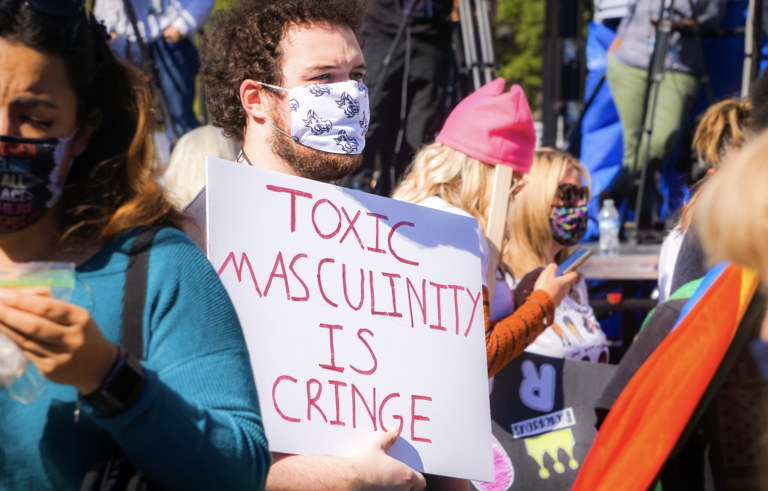 Man Holding Sign "Toxic Masculinity is Cringe"