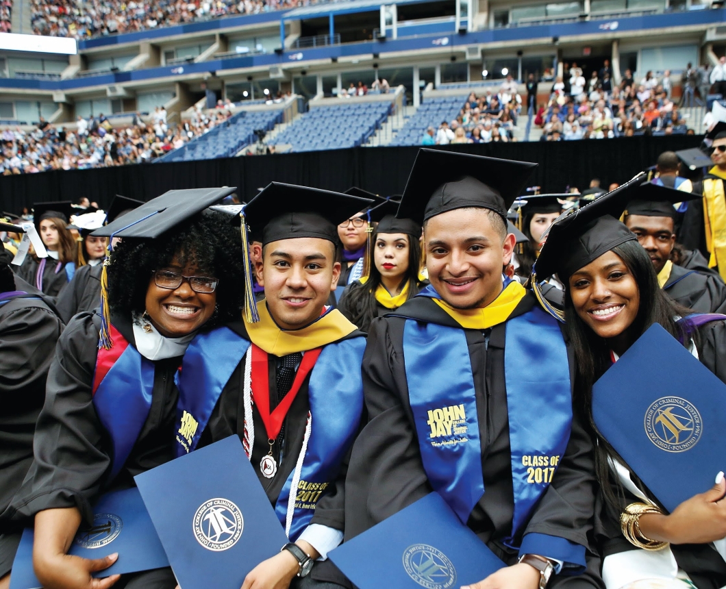 four students at commencement