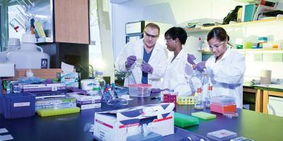 Faculty and students in a lab