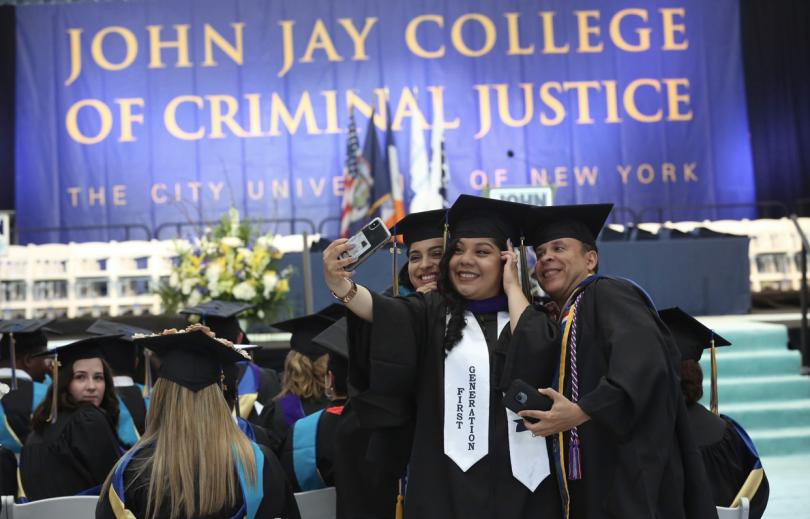 Graduates taking a selfie.