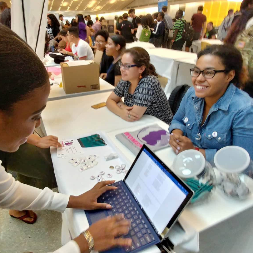 A student signing up for a club at the semesterly Involvement Fair.